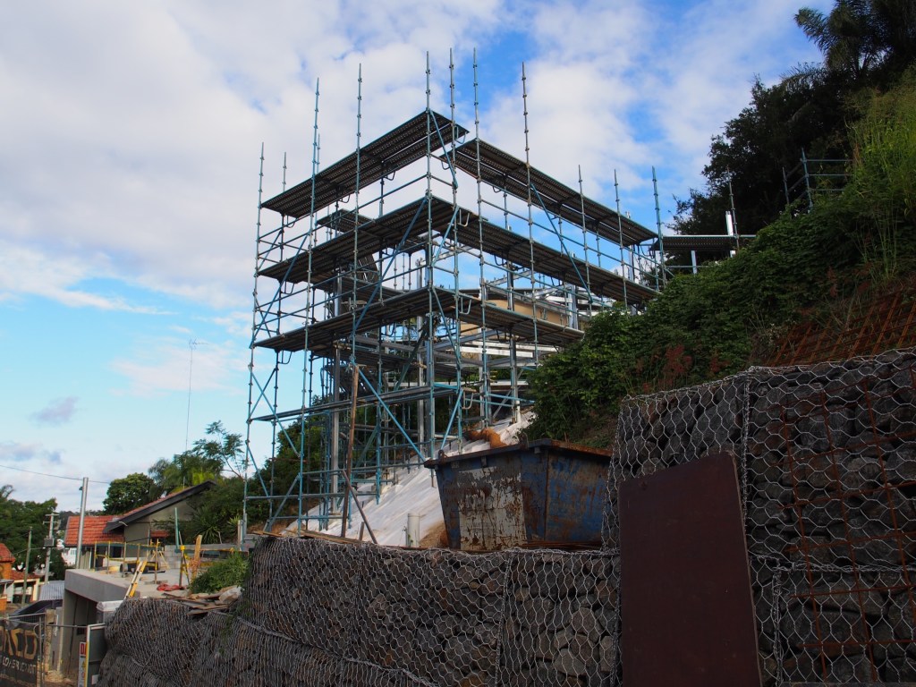 The scaffolding surrounds the frame so they can work on it.