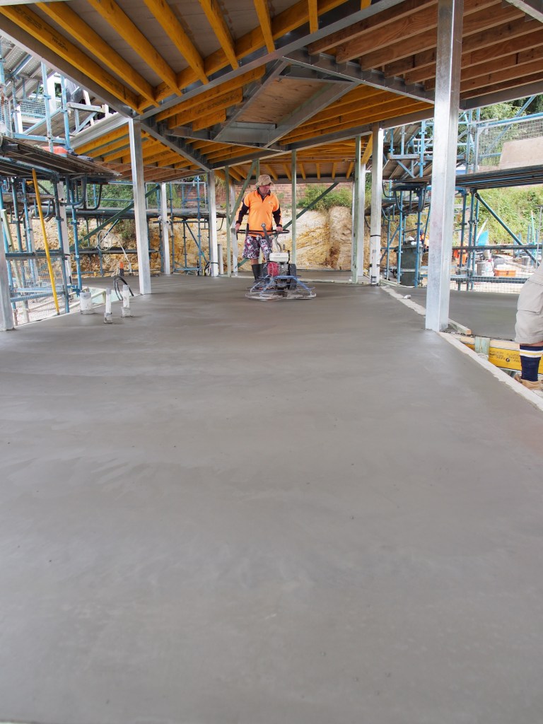 Burnishing the slab on the lower floor.
