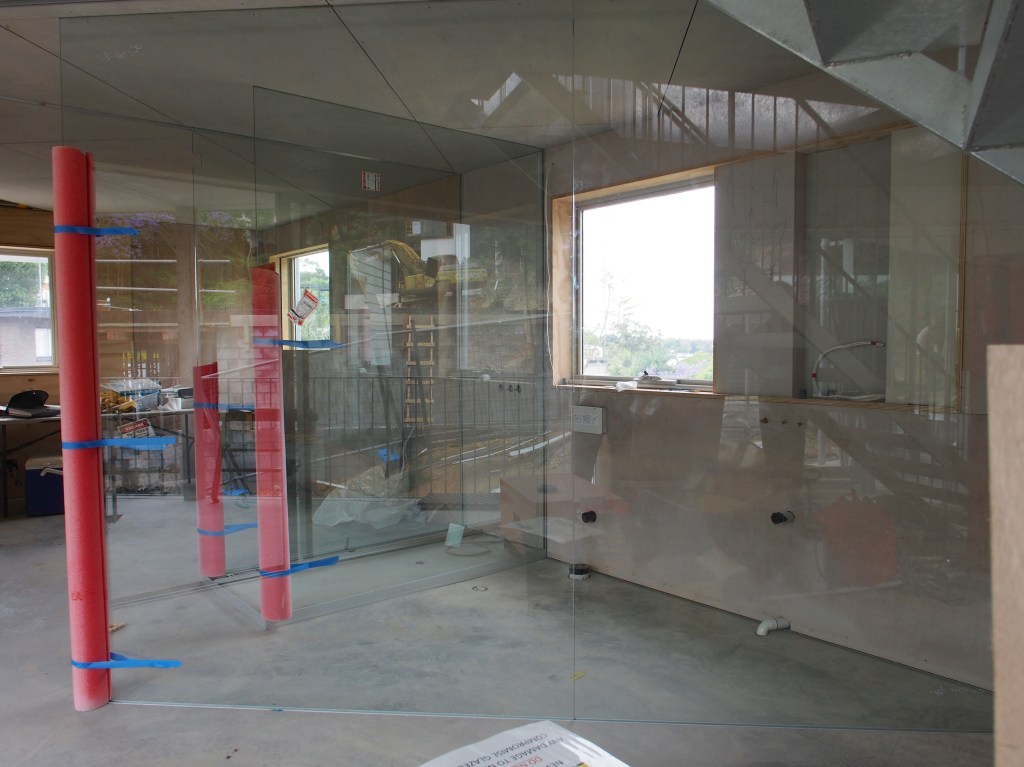 Looking through the glass bathroom to the bedroom.
